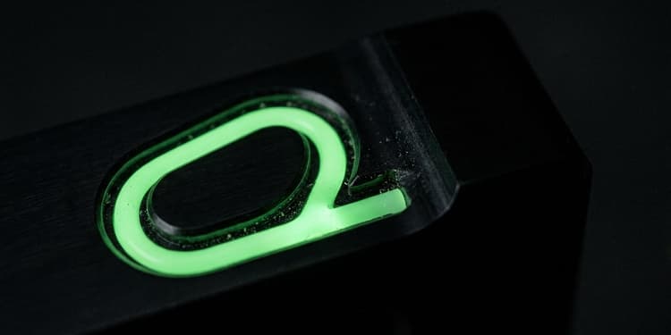 A green channel cut into black that curves back into itself in a closed loop with one branch dead-ending