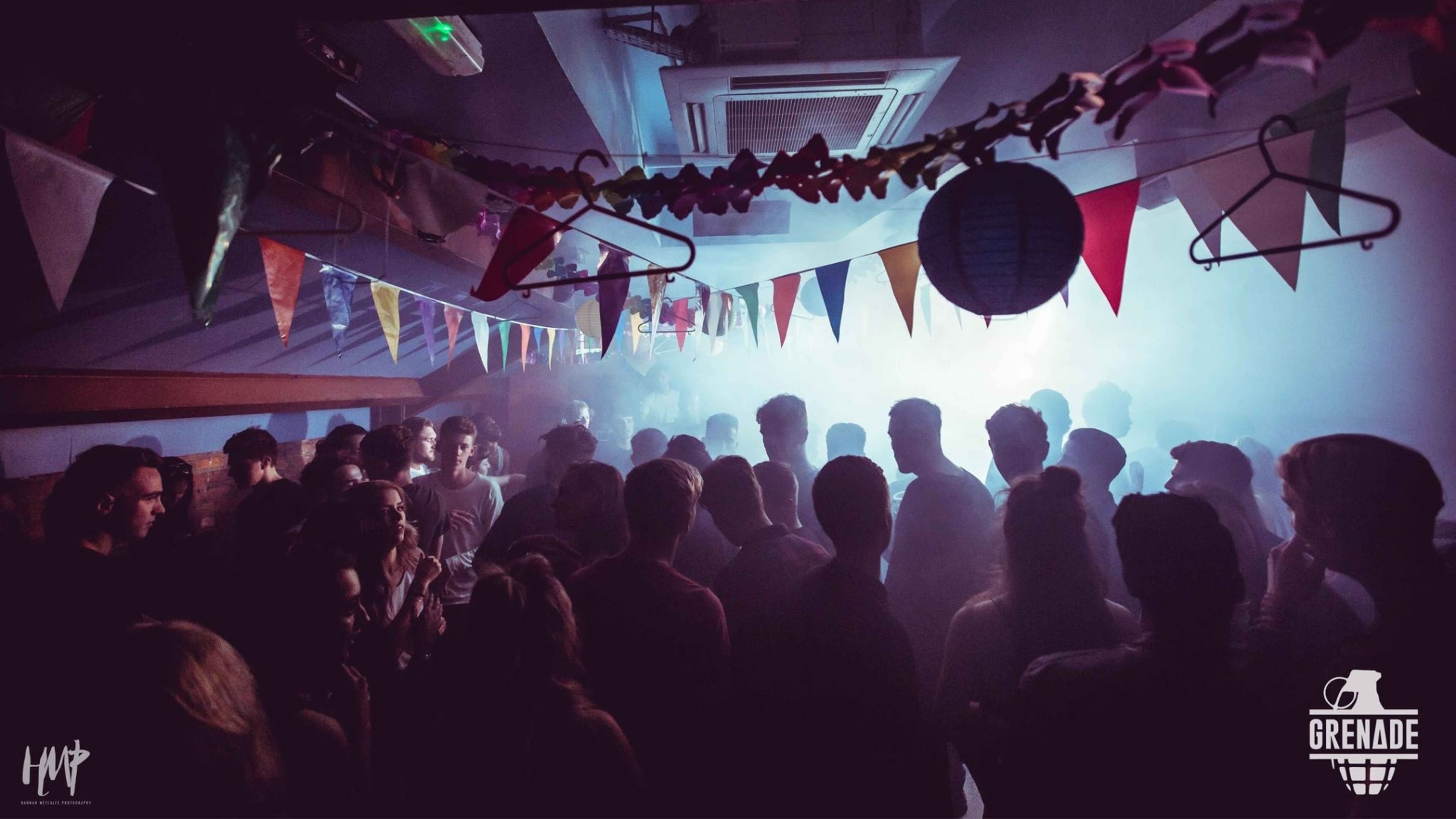 Crowd inside a bunting-decorated venue at a Grenade event, 2015