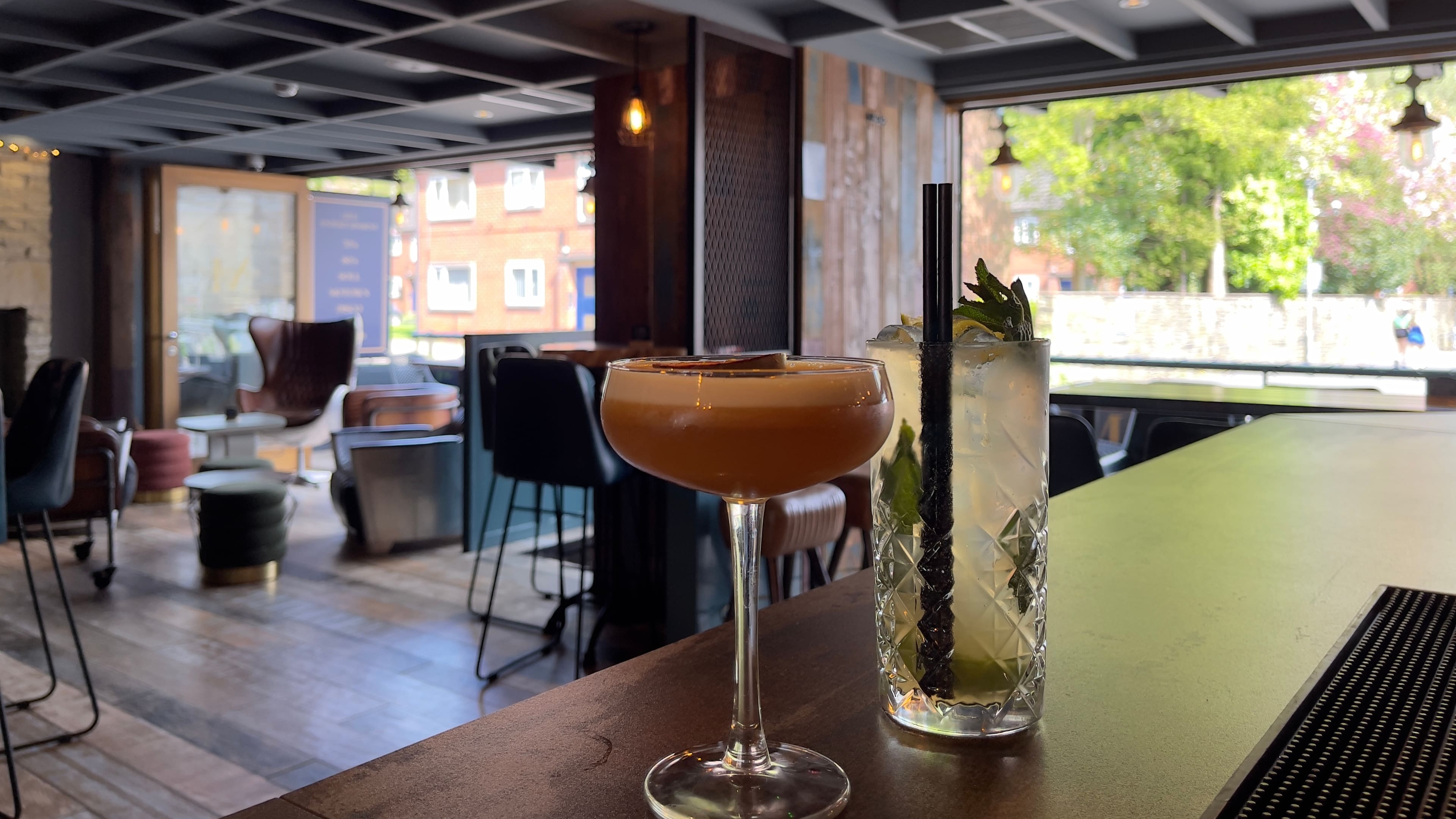 Bar interior with cocktails on the counter, 2023