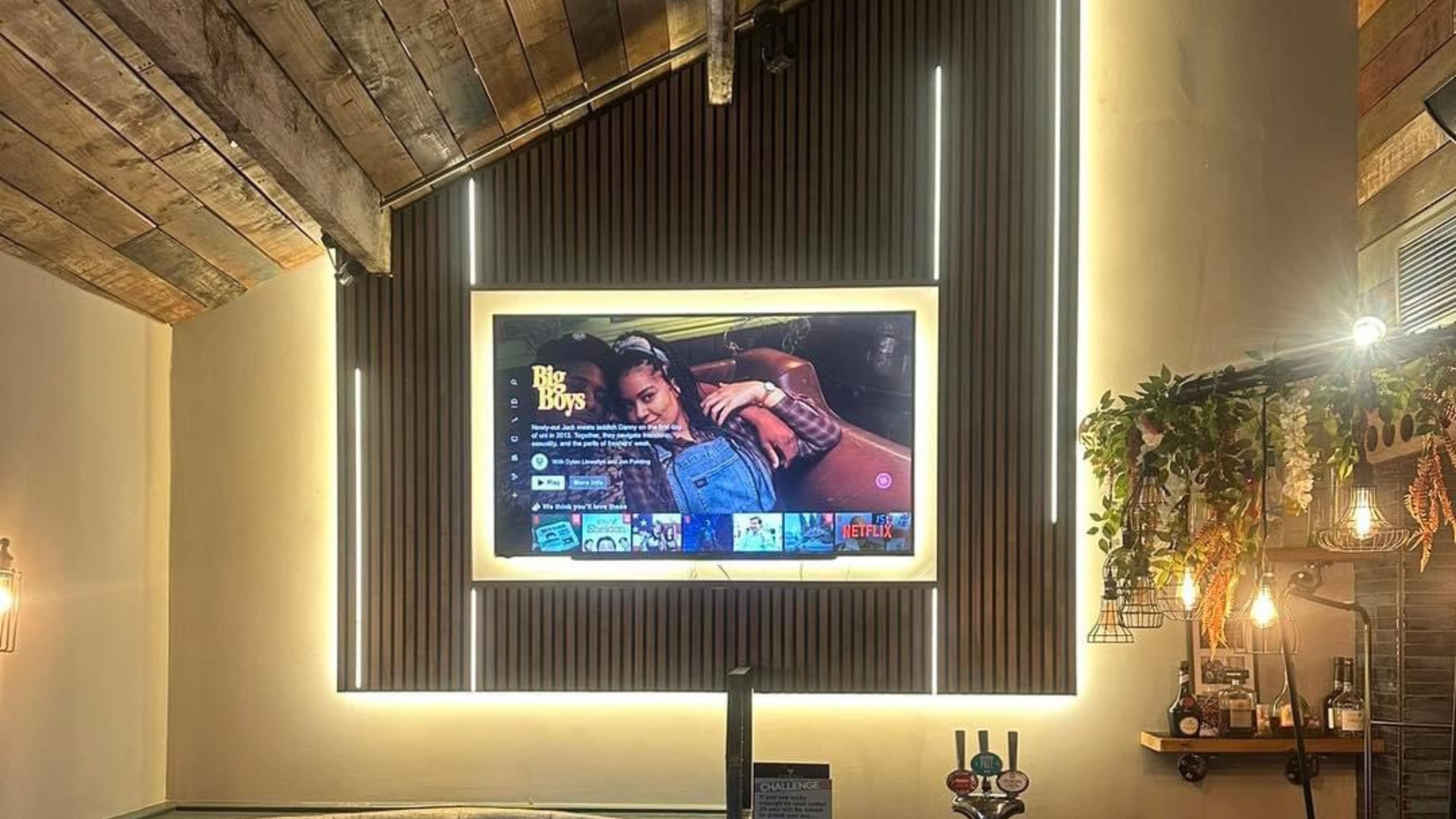 Feature media wall with warm lighting inside the bar, 2023